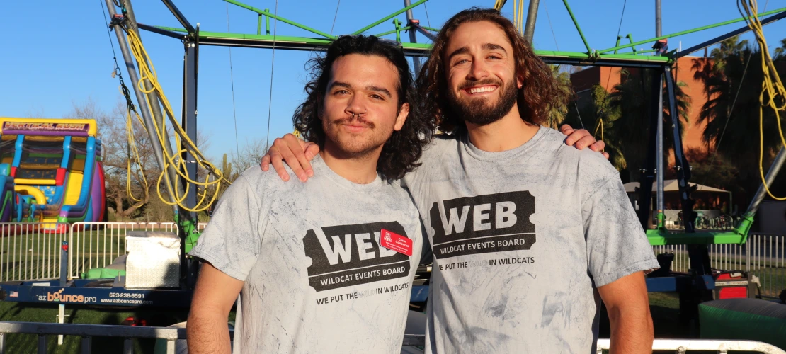 two students at event hugging